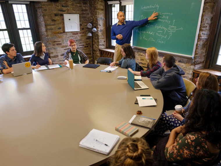 Students sitting in class, round conference table