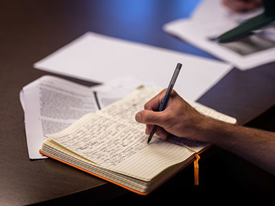 A hand writing in a journal