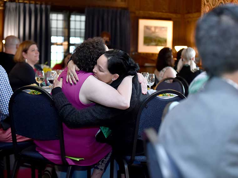 People embracing at reunion event