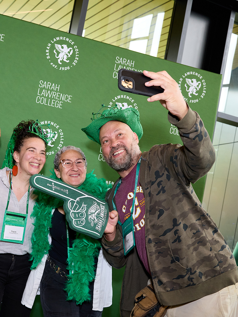 Alumni smiling and taking a selfie