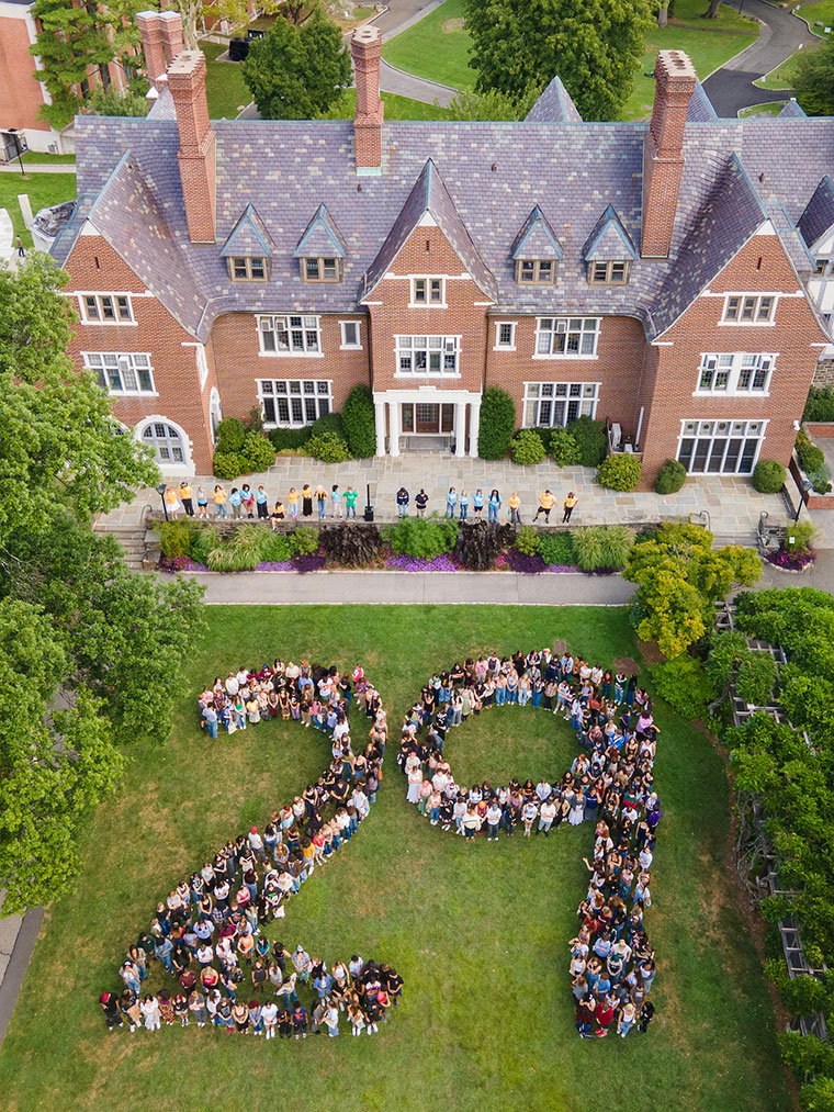 Students posing in the shape of 29