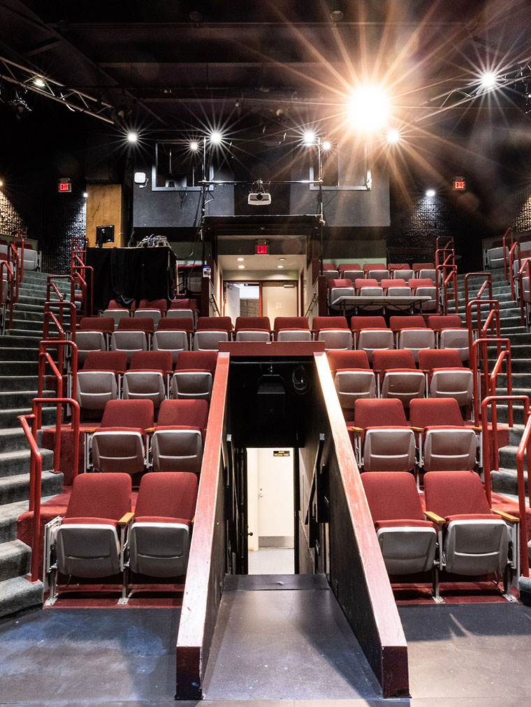 A theatre at Sarah Lawrence college with a light shining above rows of seats