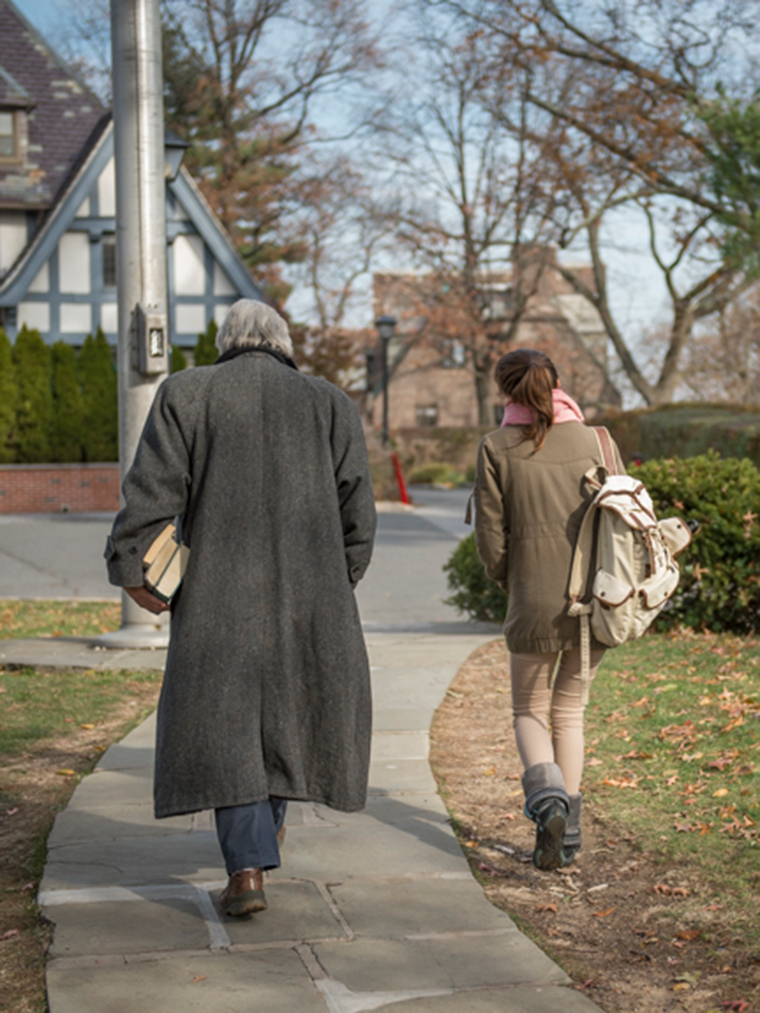 Faculty member and student walk toward Westlands