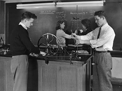 Two men and two women in a science class in the 1940s
