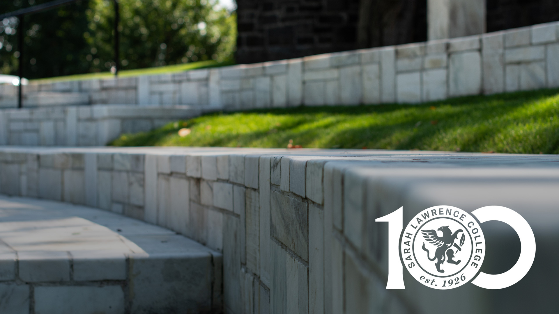 Close up of the marble of the Remy Theatre with the SLC100 logo over it