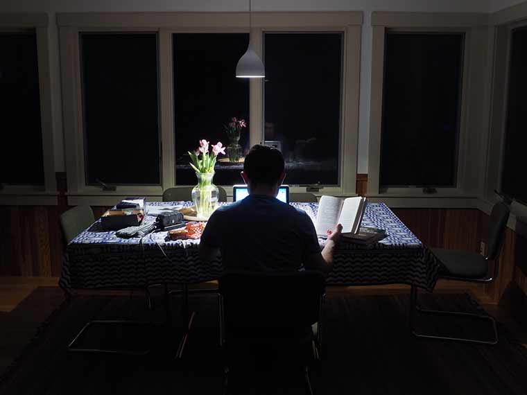 Student working at kitchen table