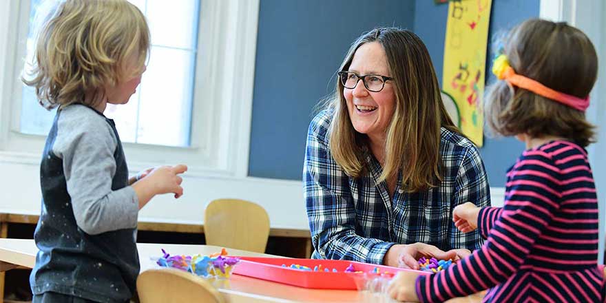 Early childhood teacher with two school children