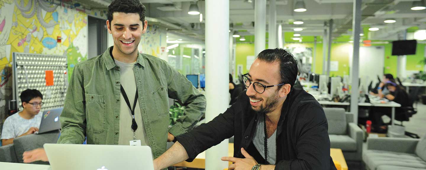 A student in conversation with an employer at his internship