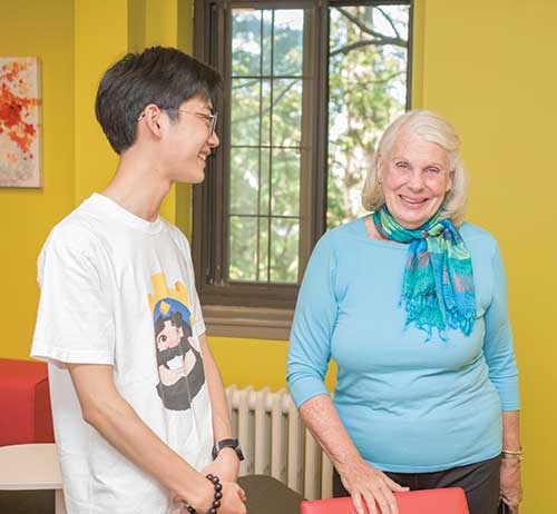 Vicki Ford visits with a student in OSilas