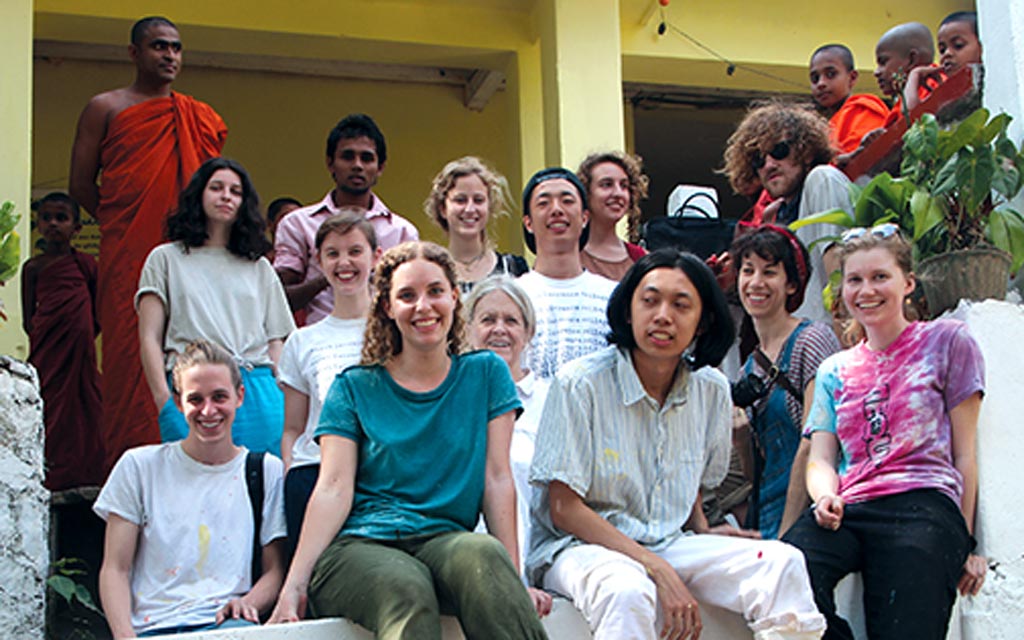 Group photo of more than a dozen people standing outside