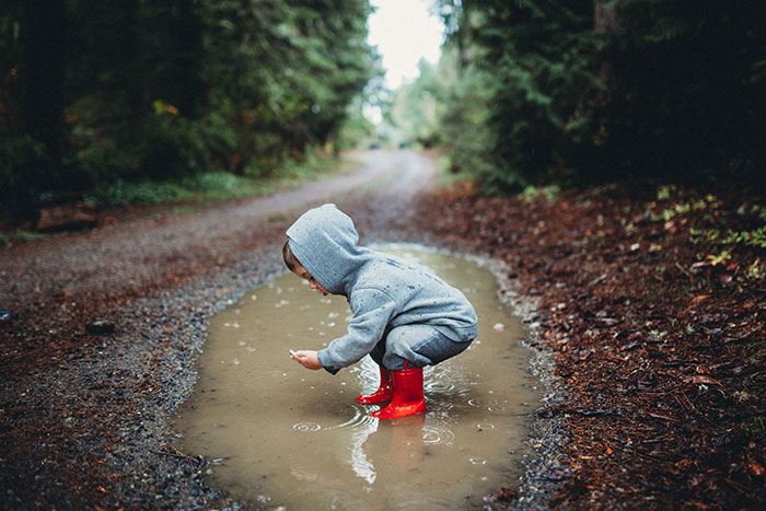 Child playing in puddle