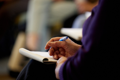 Teacher taking notes at an event