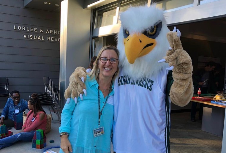 Photo of Gryphon mascot with Lorayne Carbon, director of the Early Childhood Center