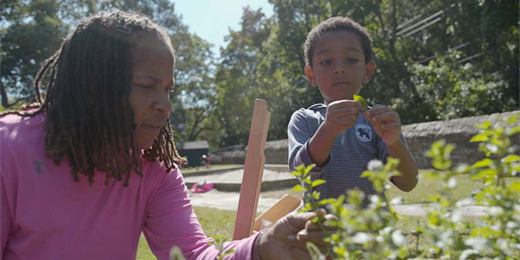 ECC teacher with children in garden