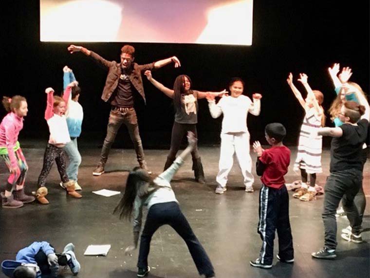 Dance activity with student volunteers and community children