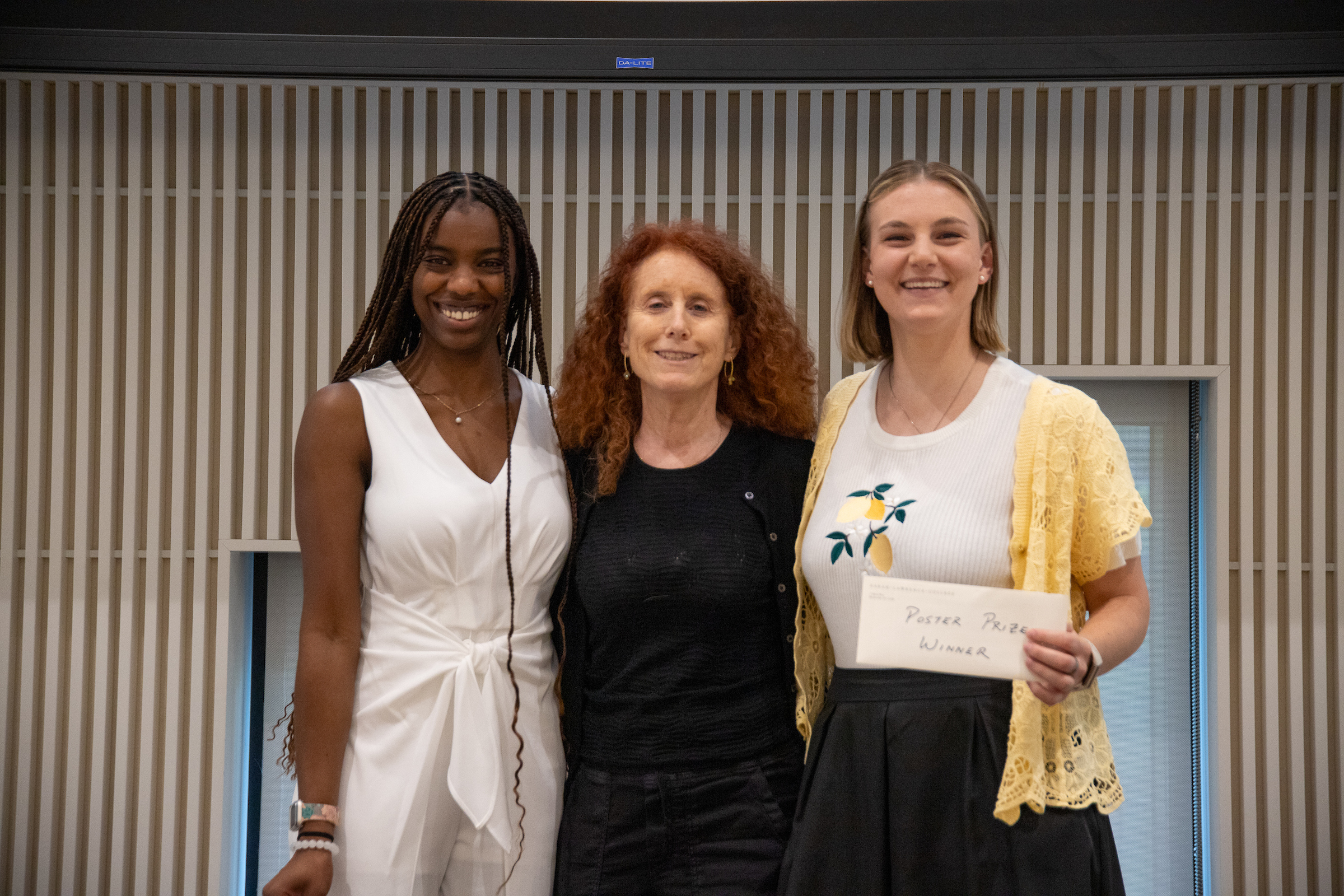 Three women standing together posing for a photo