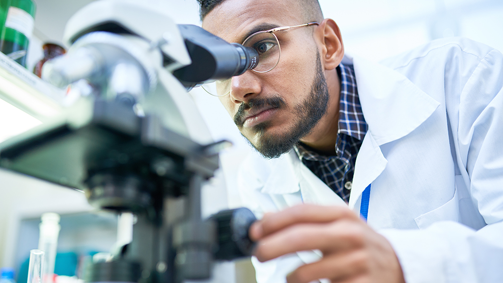 A man looking through a microscope