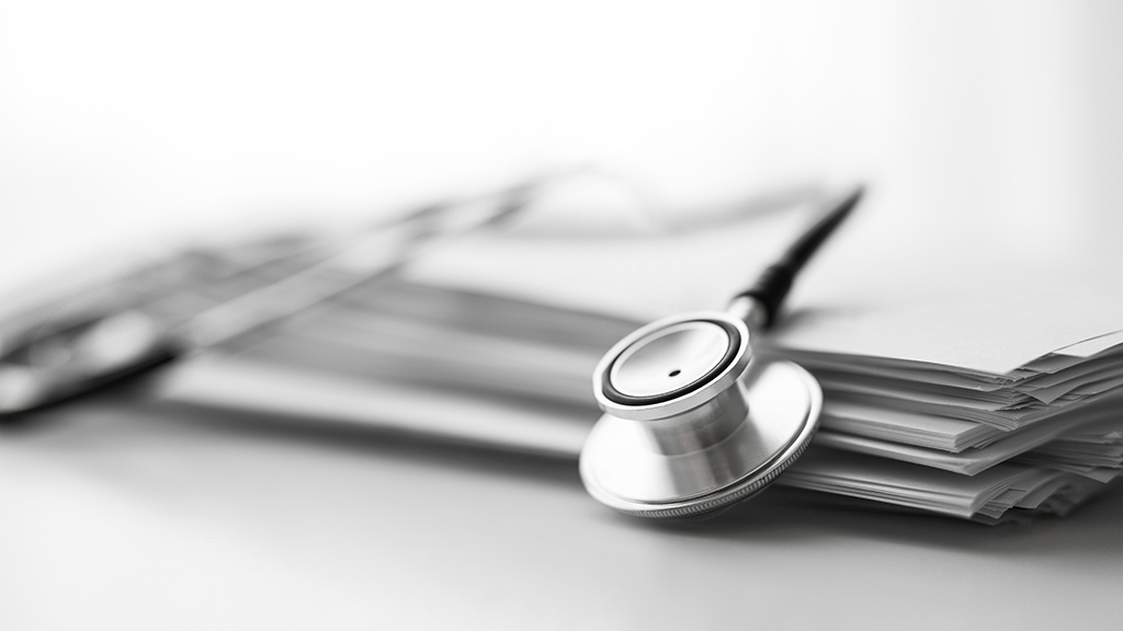 A stethoscope lying on a notebook