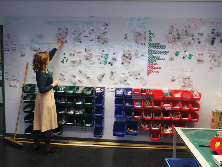 Robbins in the lab at Delft University of Technology, amid sensors, actuators, microcontroller boards, and other components.