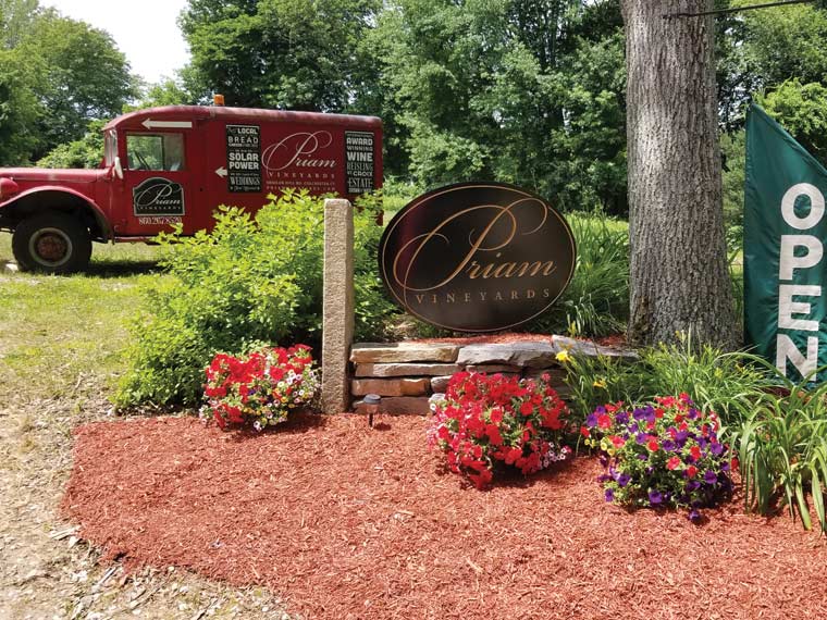 Photo of entrance to vineyard, showing sign that reads, Priam Vineyards