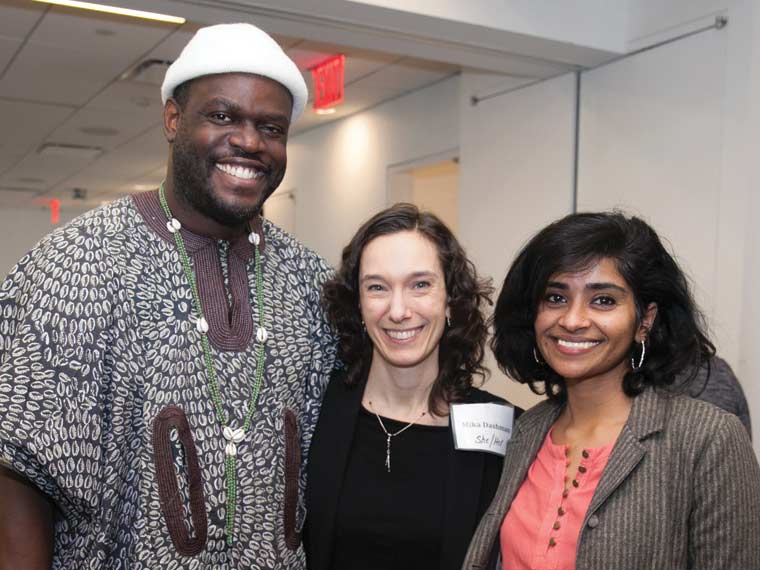 Photo of three people standing together