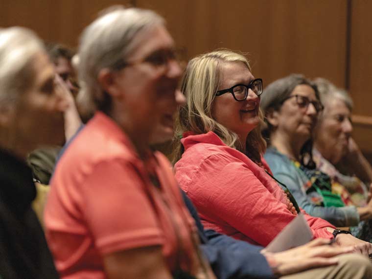 Audience members watching the discussion on stage