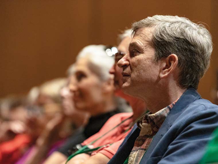 Audience members watching the discussion on stage