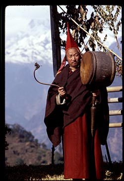 A Shinglay lama beating a traditional drum