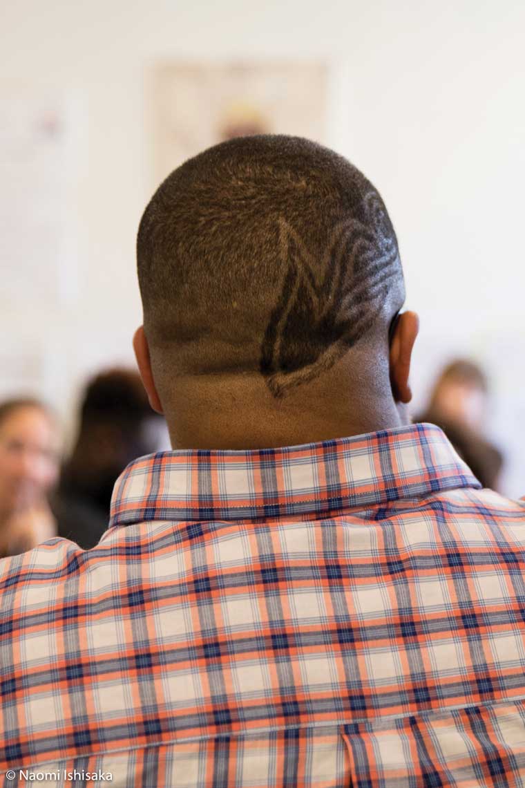 Back of mans head with pattern shaved into hair