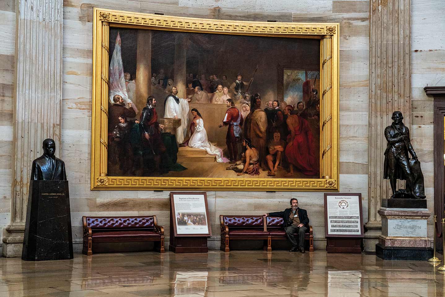 Andrew Lichtenstein ’88 in the US Capitol Rotunda, seated beneath the painting Baptism of Pocahontas, between busts of Martin Luther King, Jr. and President Thomas Jefferson on the night of President Trump’s impeachment.