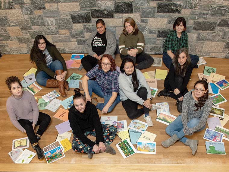 Several of the students who have participated in Right to Write during the 2019-20 academic year are surrounded (above) by anthologies representing the incarcerated writers whose work has been read at the College’s annual poetry festival over the past 25 years. Clockwise from upper left are Micaela Eckett ’21, Keya Acharya ’20, Aubrey Baker ’23, Genevieve Mills MFA ’21, Cat Adler-Josem MFA ’21, Bella Phelan ’22, Lucia Lansing ’20, KT Herr MFA ’20, Sidney Wegener MA ’21, and Emma Hochfelder ’20.