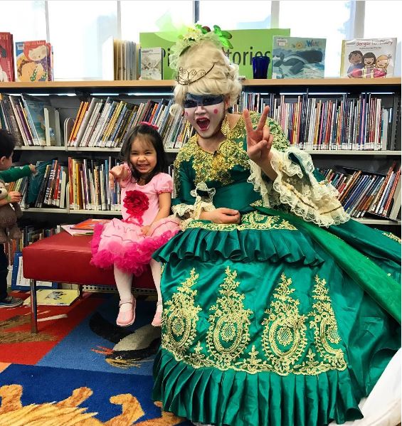 Young child posing with drag queen