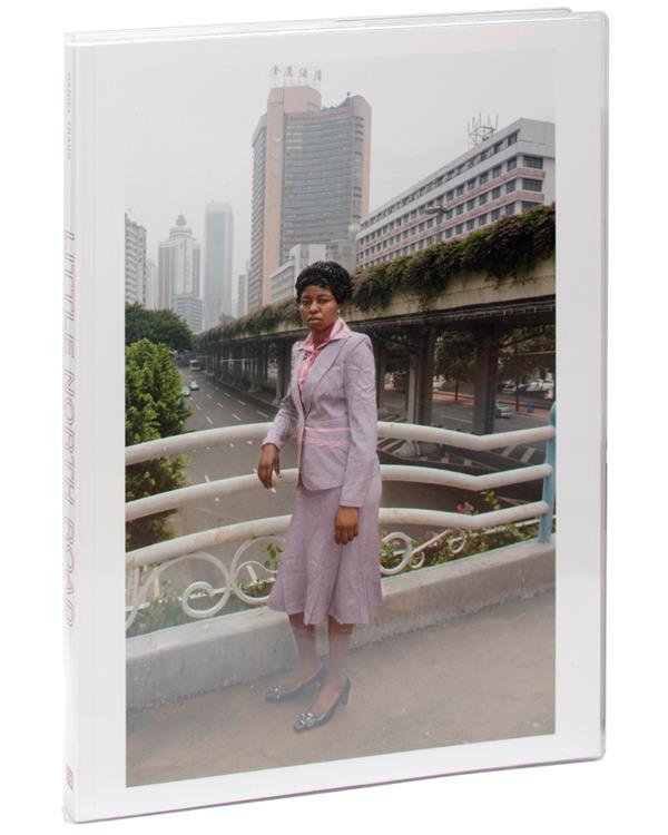 Book cover with woman standing with city in background