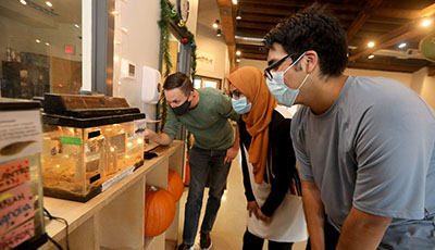 Photo of Jason Muller and students looking in a fish tank