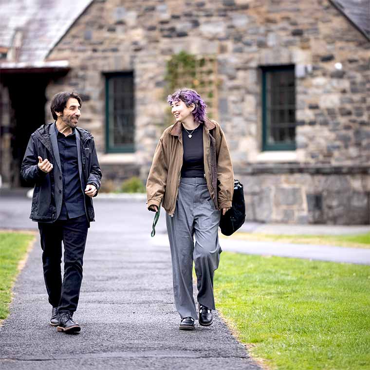 two people in conversation walking outside