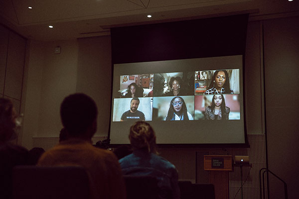 Photo of audience watching panel discussion