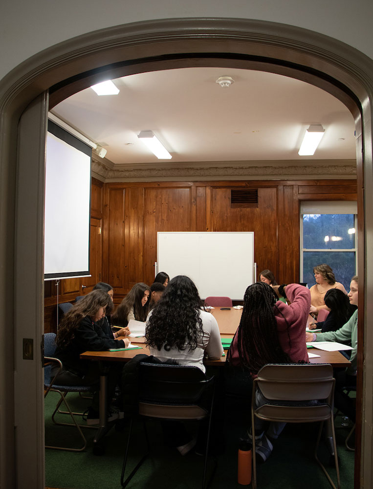 Students gathered around a roundtable in Wrexham