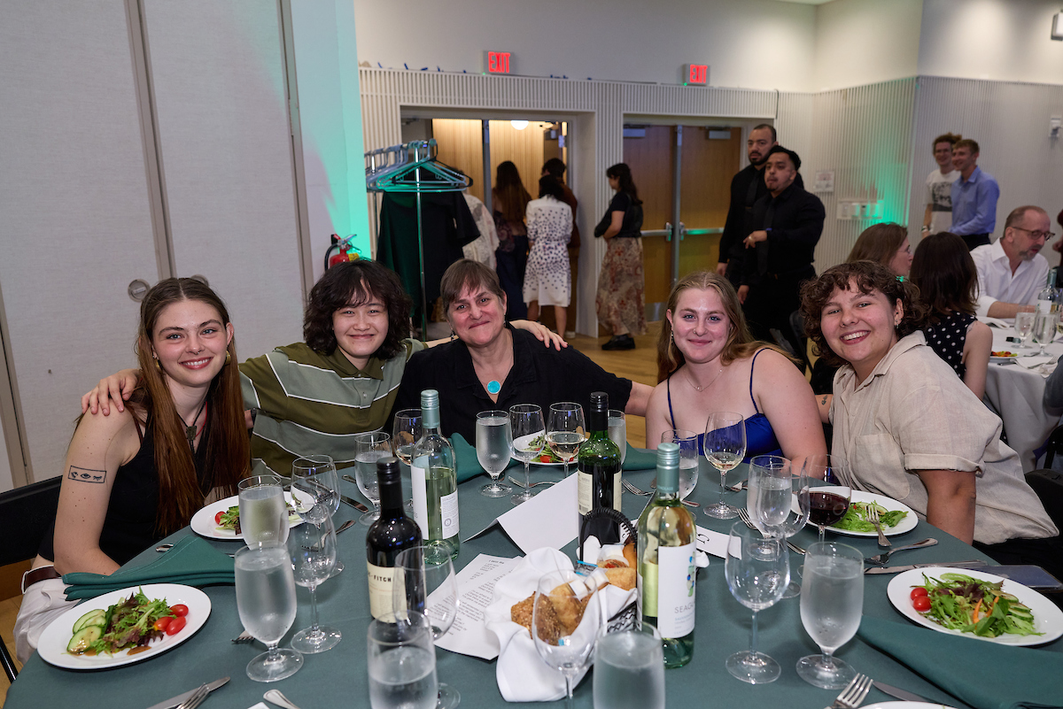 Faculty member and students posing at faculty/student gala