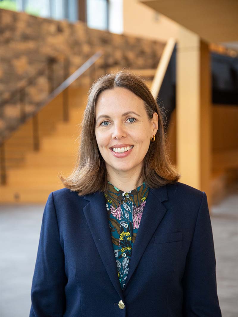 Woman in blue blazer smiling at camera