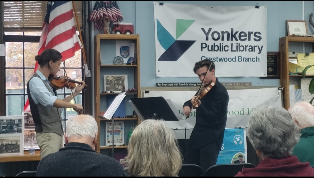 Raphael Hendrick-Baker ’26, left, and Eloy Pampin ’27 performing at the Crestwood Library