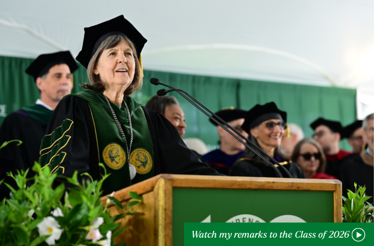 President Judd speaking at the podium with a call to action to click to watch her remarks