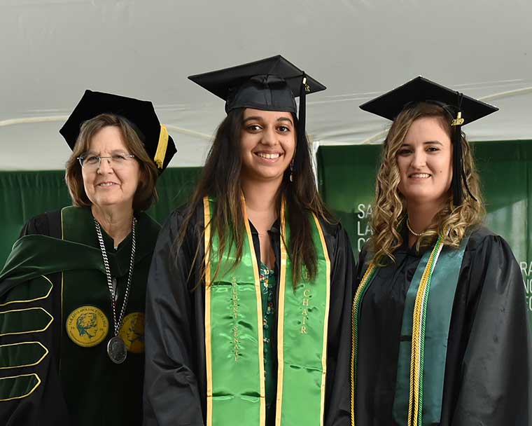 President Judd with two graduates