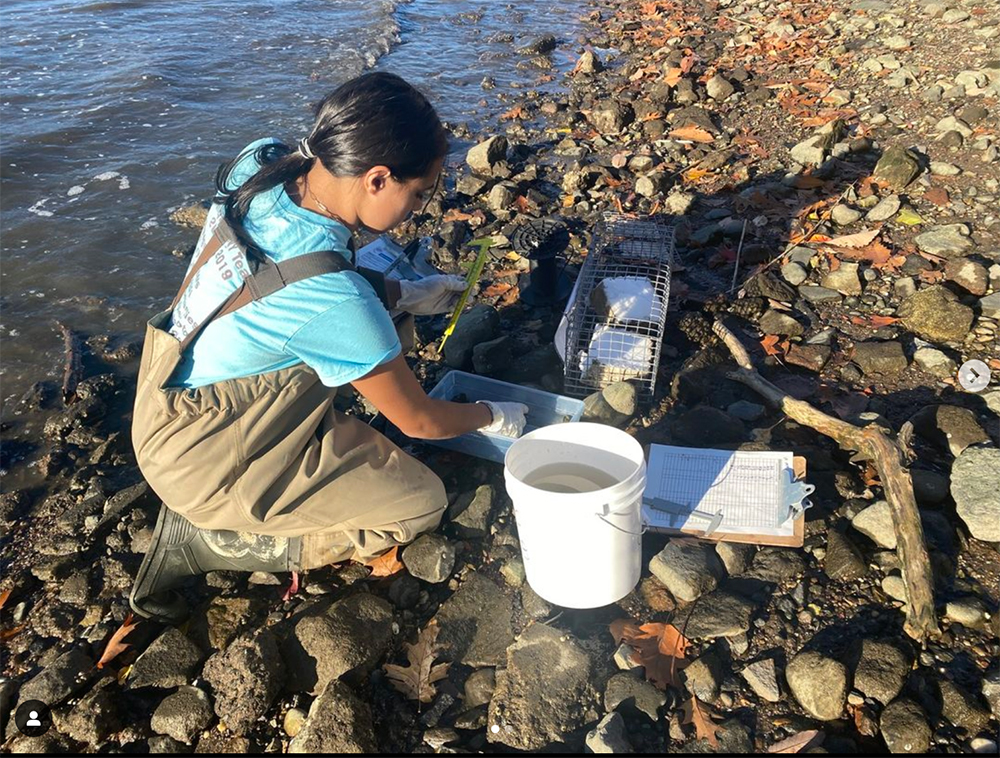 A high school student conducts research in the Hudson River