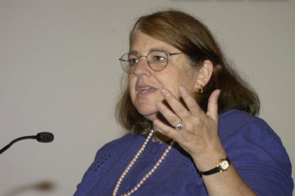 Jan Drucker speaking at a microphone