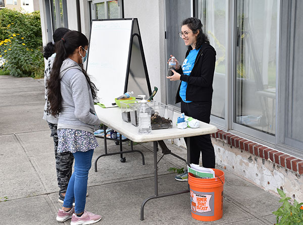 A teacher showing students samples from the Hudson River