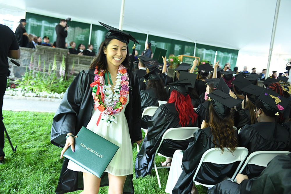 A student shows off her diploma