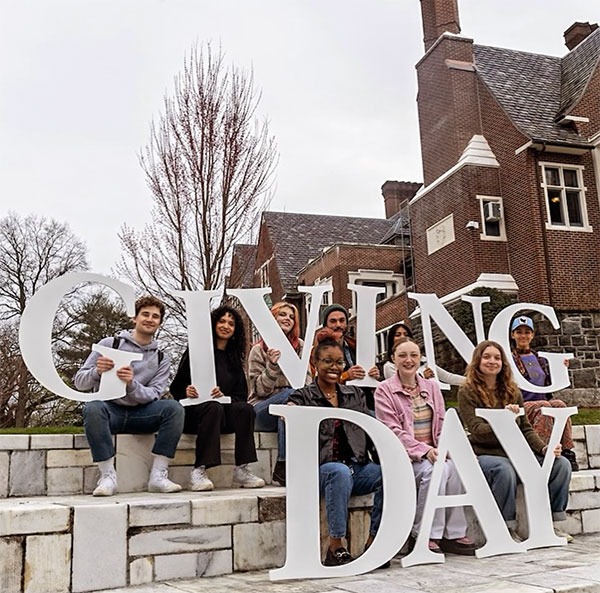 Students holding letters that spell Giving Day
