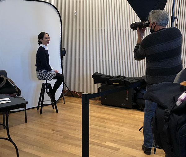 A student takes part in a professional headshot session