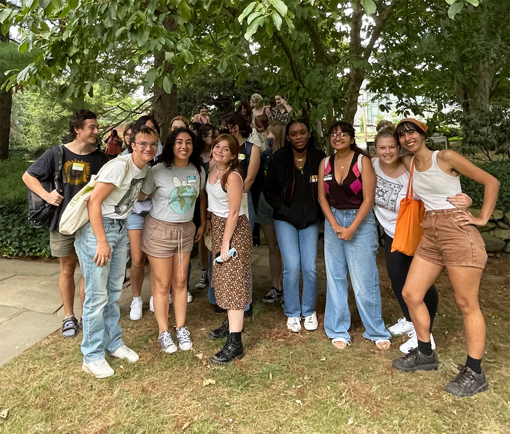 A group of student resident advisors under a tree