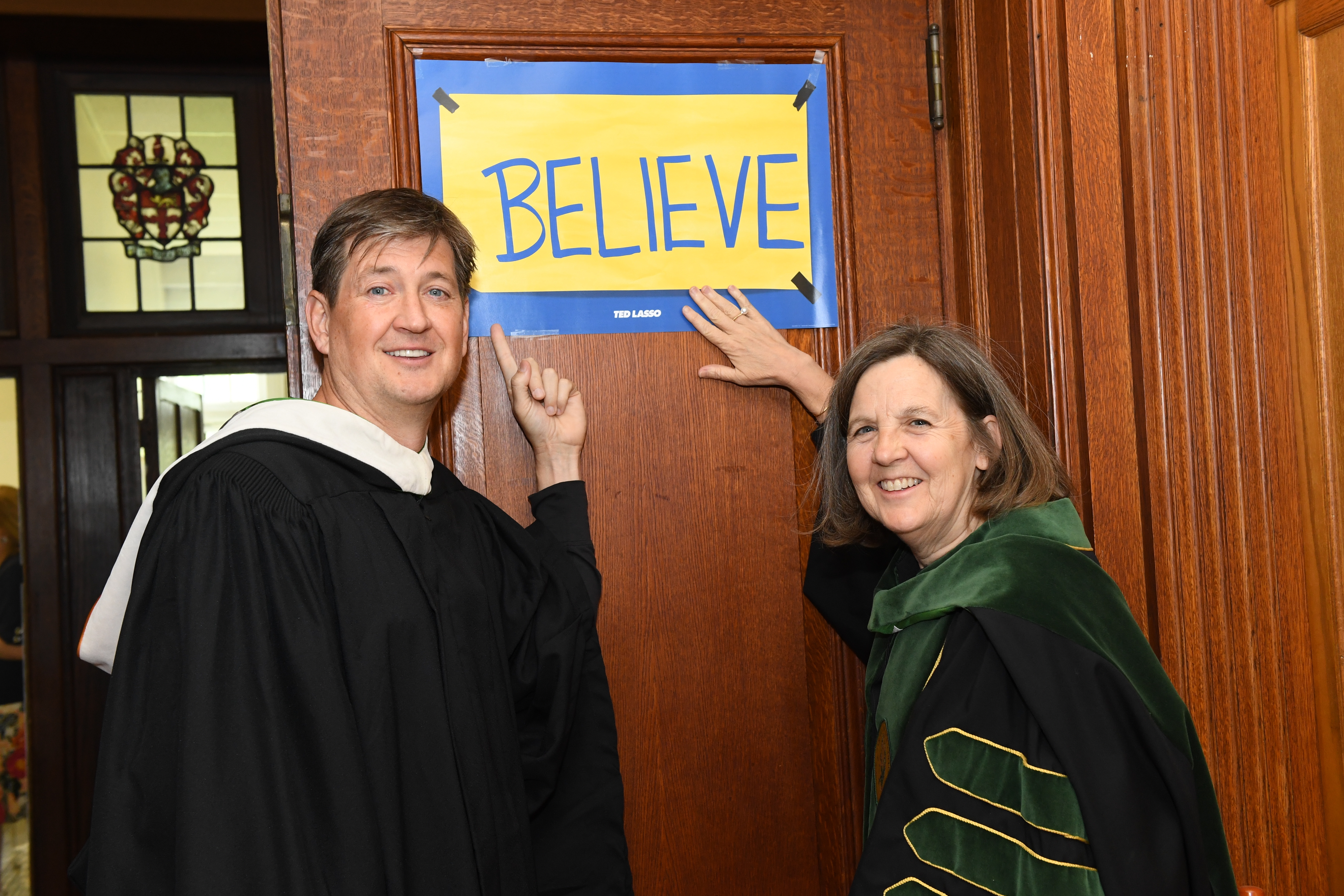 Bill Lawrence and Cristle Collins Judd pose under a "Believe" sign